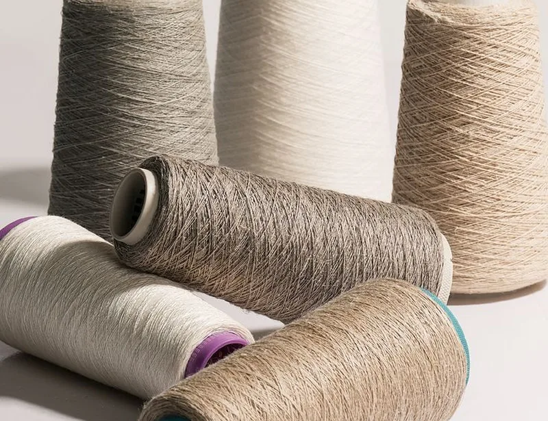 Cones of cotton and natural yarn in different shades